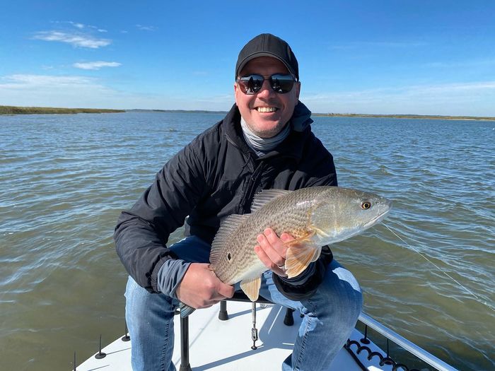 Angler holding a redfish on the flats