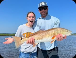 Couple holding a redfish