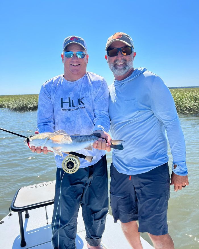 Two anglers with a fish caught on the fly